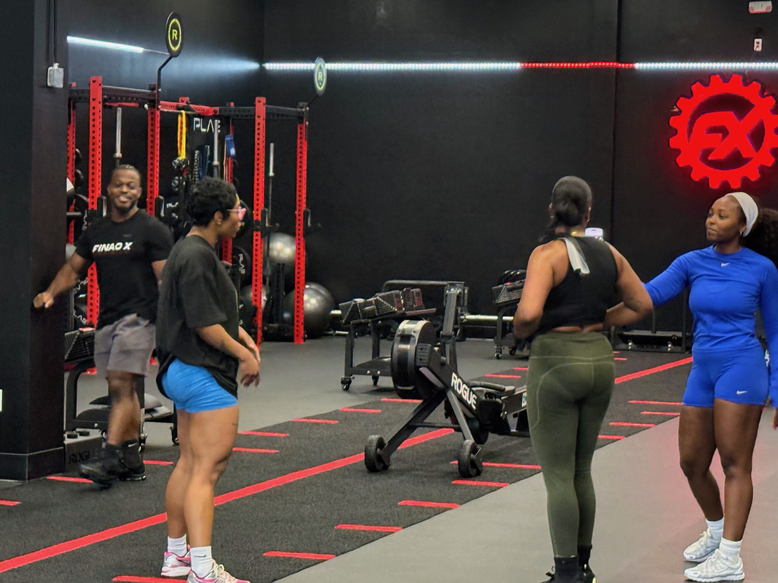 Member performing weighted lunge during group fitness at FINAO X in Sandy Springs, GA